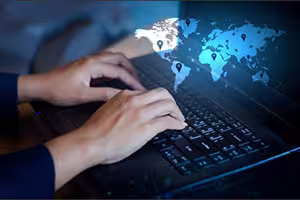 Hands typing world map